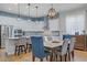 Open concept of a dining area with view of the kitchen featuring stainless appliances and barstool seating at 390 Inflection St, Henderson, NV 89011