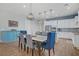 Bright open plan with dining room leading to a modern kitchen with an island bar at 390 Inflection St, Henderson, NV 89011