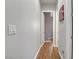 Hallway with wood floors and neutral paint leads to bedrooms and bathrooms at 390 Inflection St, Henderson, NV 89011