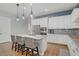 Bright kitchen features stainless steel appliances, modern light fixtures, and a large island at 390 Inflection St, Henderson, NV 89011