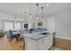 Open concept kitchen features a stainless steel dishwasher, island seating and sleek lighting at 390 Inflection St, Henderson, NV 89011