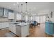 Open kitchen and dining area, featuring stainless steel appliances and an island with bar seating at 390 Inflection St, Henderson, NV 89011