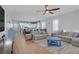 Open-concept living room with view of the kitchen, wood floors, and bright natural light at 390 Inflection St, Henderson, NV 89011