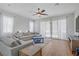 Bright living room with wood floors, ceiling fan, and comfortable couches at 390 Inflection St, Henderson, NV 89011