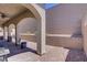 Covered patio area with ceiling fan, brick flooring, and privacy wall at 390 Inflection St, Henderson, NV 89011