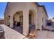 Back patio area with outdoor grill and seating beneath covered archways at 390 Inflection St, Henderson, NV 89011
