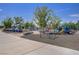 Community playground featuring swings, slides, climbing structures, and a rubber surface for safety and fun at 390 Inflection St, Henderson, NV 89011