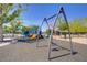 Community playground featuring swings, slides, and lush trees at 390 Inflection St, Henderson, NV 89011