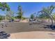 Community playground with swings, climbing structure, and soft, safe flooring at 390 Inflection St, Henderson, NV 89011