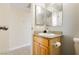 Bright bathroom featuring a unique, decorative vanity mirror and wooden cabinet sink at 408 N Torrey Pines Dr, Las Vegas, NV 89107