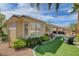 Lush backyard with artificial turf, cozy seating area, and manicured landscaping at 4134 Riva De Tierra Ln, Las Vegas, NV 89135
