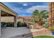 Backyard featuring a built-in barbecue area, desert landscaping, and a patio at 4134 Riva De Tierra Ln, Las Vegas, NV 89135