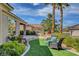 Beautiful backyard featuring desert landscaping, synthetic grass, and a patio with seating at 4134 Riva De Tierra Ln, Las Vegas, NV 89135