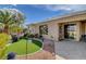 The backyard has a synthetic grass area, desert landscaping, and a covered patio at 4134 Riva De Tierra Ln, Las Vegas, NV 89135