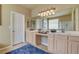 Spacious bathroom with double sink vanity, lots of natural light, and a large mirror at 4134 Riva De Tierra Ln, Las Vegas, NV 89135