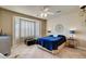 Bedroom with a bay window, shutters, ceiling fan, and modern decor at 4134 Riva De Tierra Ln, Las Vegas, NV 89135