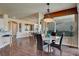 Open dining area features a round table, decorative chandelier, and large windows for ample natural light at 4134 Riva De Tierra Ln, Las Vegas, NV 89135