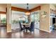 Dining area featuring decorative chandelier, round table with seating for four, and sliding doors for patio access at 4134 Riva De Tierra Ln, Las Vegas, NV 89135