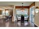 Bright dining area featuring a decorative chandelier, round table with seating, and sliding doors to the outdoor patio at 4134 Riva De Tierra Ln, Las Vegas, NV 89135