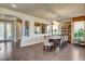 Elegant dining room featuring dark wood floors, stylish mirrors, and a modern chandelier at 4134 Riva De Tierra Ln, Las Vegas, NV 89135