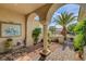 Inviting front porch with stone pavers, decorative columns, and manicured greenery at 4134 Riva De Tierra Ln, Las Vegas, NV 89135