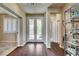 Inviting foyer with decorative glass front doors, dark wood flooring, and neutral color palette at 4134 Riva De Tierra Ln, Las Vegas, NV 89135