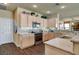 Well-lit kitchen featuring granite countertops, stainless steel appliances, wooden cabinets, and modern fixtures at 4134 Riva De Tierra Ln, Las Vegas, NV 89135