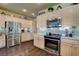 Updated kitchen with stainless steel appliances, granite countertops, and modern finishes at 4134 Riva De Tierra Ln, Las Vegas, NV 89135