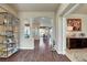Open-concept living room showcasing elegant columns, dark wood floors, and view of the dining area at 4134 Riva De Tierra Ln, Las Vegas, NV 89135