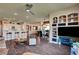 Open-concept living area with wood floors, bar seating, and built-in shelving at 4134 Riva De Tierra Ln, Las Vegas, NV 89135