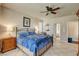 Spacious main bedroom with a ceiling fan, tiled flooring, and ample natural light at 4134 Riva De Tierra Ln, Las Vegas, NV 89135