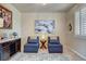 Relaxing sitting room with two lounge chairs, neutral decor, and bright natural light at 4134 Riva De Tierra Ln, Las Vegas, NV 89135
