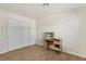 Bright bedroom with wood-look flooring, desk, and closet with louvered doors at 4573 Plaza De Vista St, Las Vegas, NV 89120