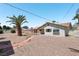 Exterior view of the home, showcasing a palm tree, desert landscaping, and architectural details at 4573 Plaza De Vista St, Las Vegas, NV 89120