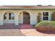 Close-up of the arched front entrance featuring iron gate, and attractive shrubbery at 4573 Plaza De Vista St, Las Vegas, NV 89120