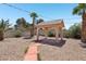 Covered gazebo in the backyard with desert landscaping and palm trees at 4573 Plaza De Vista St, Las Vegas, NV 89120
