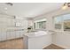 Bright kitchen featuring white cabinetry, modern appliances, and breakfast bar area at 4573 Plaza De Vista St, Las Vegas, NV 89120