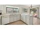 Bright kitchen has white cabinets, double sinks, and breakfast bar area at 4573 Plaza De Vista St, Las Vegas, NV 89120