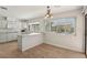 Kitchen with white cabinets, breakfast bar, and tile floors offers backyard view at 4573 Plaza De Vista St, Las Vegas, NV 89120
