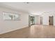 Open living area with wood tile flooring and access to the backyard through French doors at 4573 Plaza De Vista St, Las Vegas, NV 89120