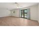 Living room with light wood-look floors and glass doors that open to the outdoors at 4573 Plaza De Vista St, Las Vegas, NV 89120
