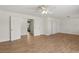 Living room with wood-look floors and view into another bedroom at 4573 Plaza De Vista St, Las Vegas, NV 89120