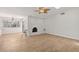 Open-concept living room with brick fireplace and updated flooring at 4573 Plaza De Vista St, Las Vegas, NV 89120