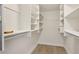 Walk-in closet featuring built-in shelving and wooden floors at 4573 Plaza De Vista St, Las Vegas, NV 89120