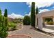 This backyard boasts a well-manicured garden with trees and a seating area for outdoor relaxation at 4765 N Grand Canyon Dr, Las Vegas, NV 89129