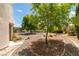 This backyard offers shade from mature trees and a desert landscape that reduces maintenance at 4765 N Grand Canyon Dr, Las Vegas, NV 89129