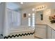 Bright bathroom features tub, shower, and white tile at 4765 N Grand Canyon Dr, Las Vegas, NV 89129