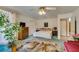 Well-lit bedroom with a large rug, king bed, and a decorative plant at 4765 N Grand Canyon Dr, Las Vegas, NV 89129