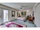 Bright bedroom features a bed, light green carpet, outdoor access and a ceiling fan at 4765 N Grand Canyon Dr, Las Vegas, NV 89129