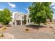 This stunning house has lush landscaping, a stucco exterior, and architectural interest from all angles at 4765 N Grand Canyon Dr, Las Vegas, NV 89129